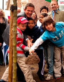 Mathew Wright assisted by school children from ICS plant trees on Hallam Street